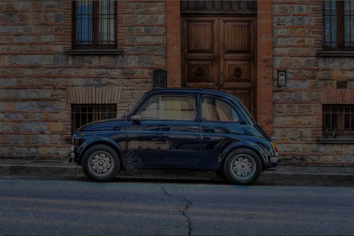 Car in front of stone building