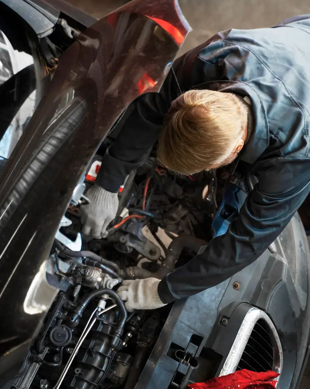 Mechanic repairing engine